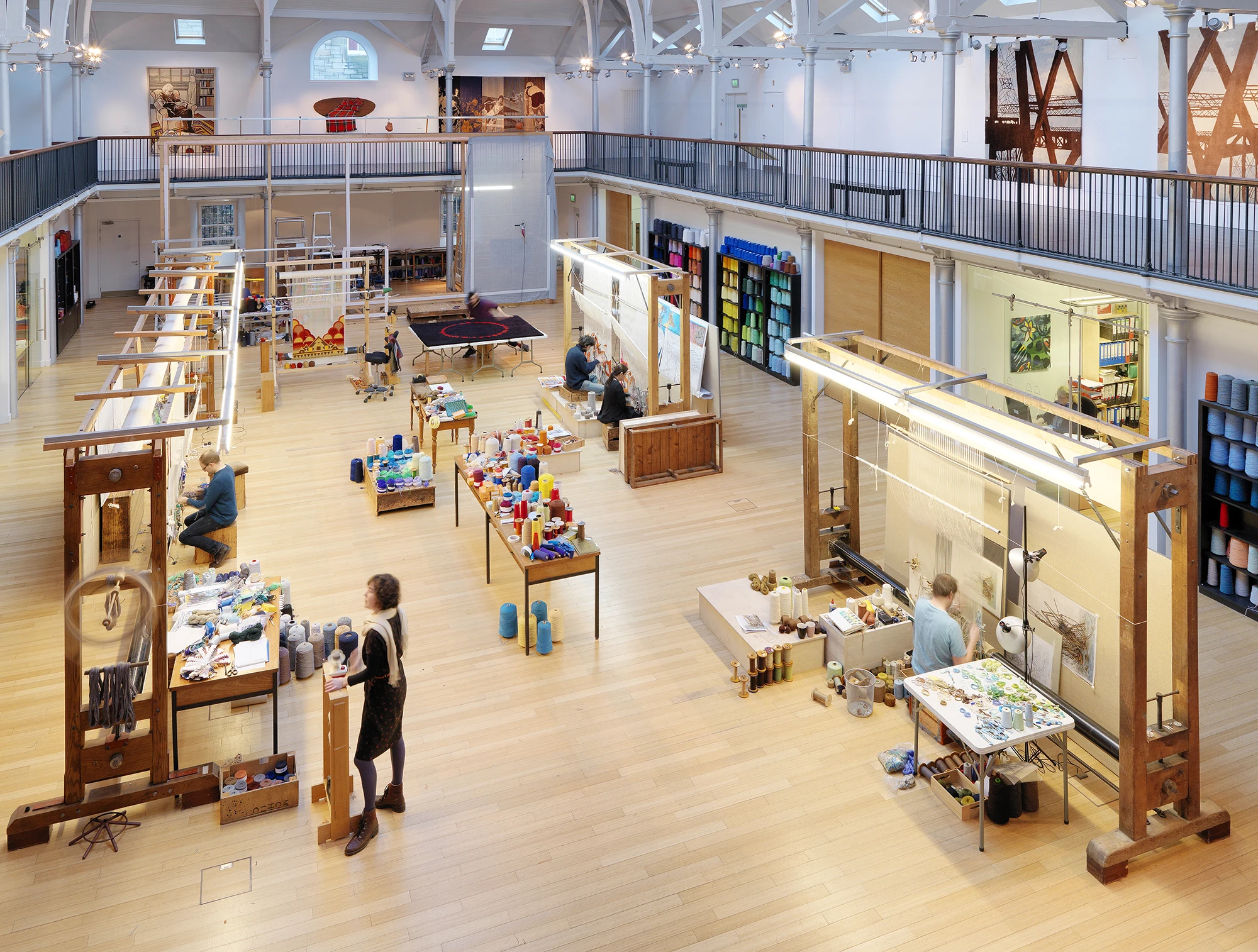 A large open space with weaving tables