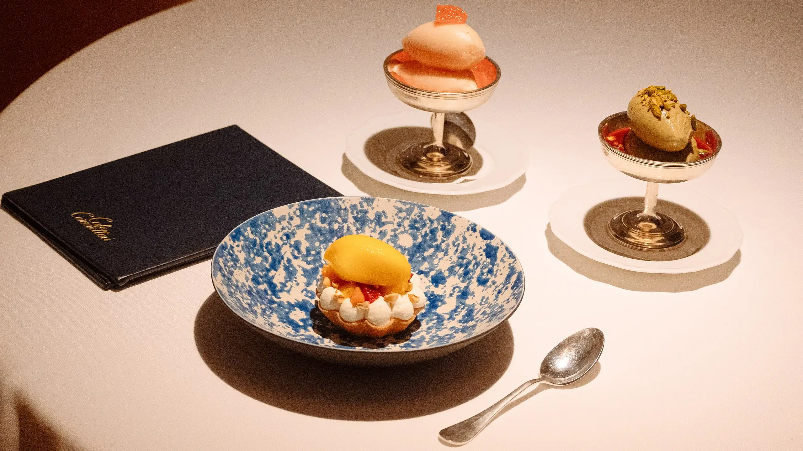 A variety of desserts presented on a white tablecloth.