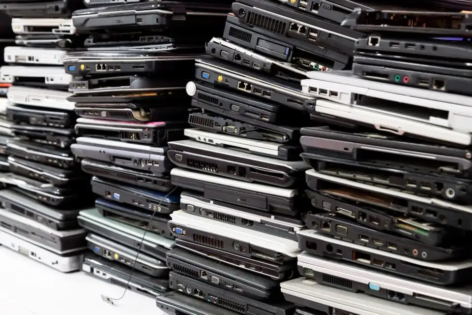 Stack of old, broken and obsolete laptop computer