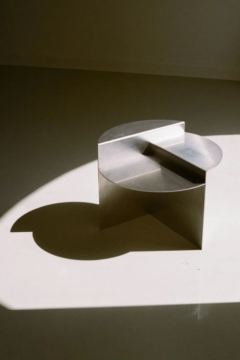 a white square object with a black circle on it a white square object with a black circle on it