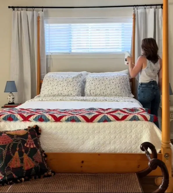 Her curtain rod interior design hack fakes symmetry and can even be done in a rental