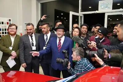 George Galloway, centre, at his Rochdale headquarters after being declared winner of the Rochdale by-election. PA via AP