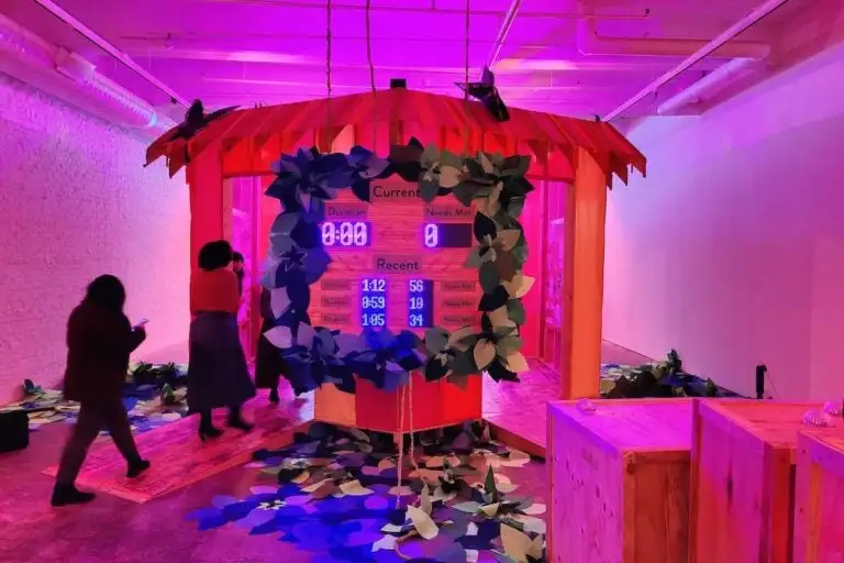 A room bathed in pink light with a scoreboard visible