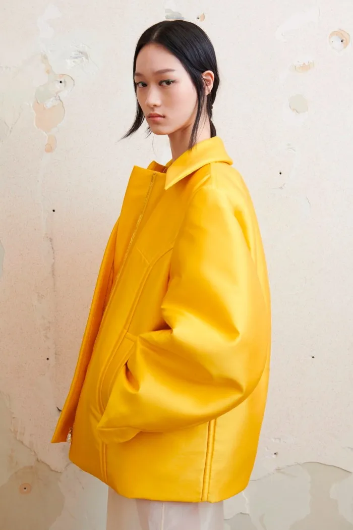 Female model wearing a yellow jacket