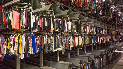 Courtesy of ThredUp The sheer volume of clothing that arrives at distribution centres for clothing resale companies, like ThredUp, can be overwhelming to process (Credit: Courtesy of ThredUp)