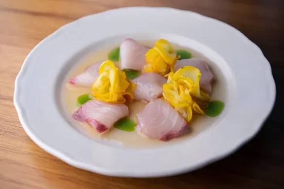 Hiramasa kingfish crudo with a bitey white soy, yuzu, ginger and rice vinegar dressing.