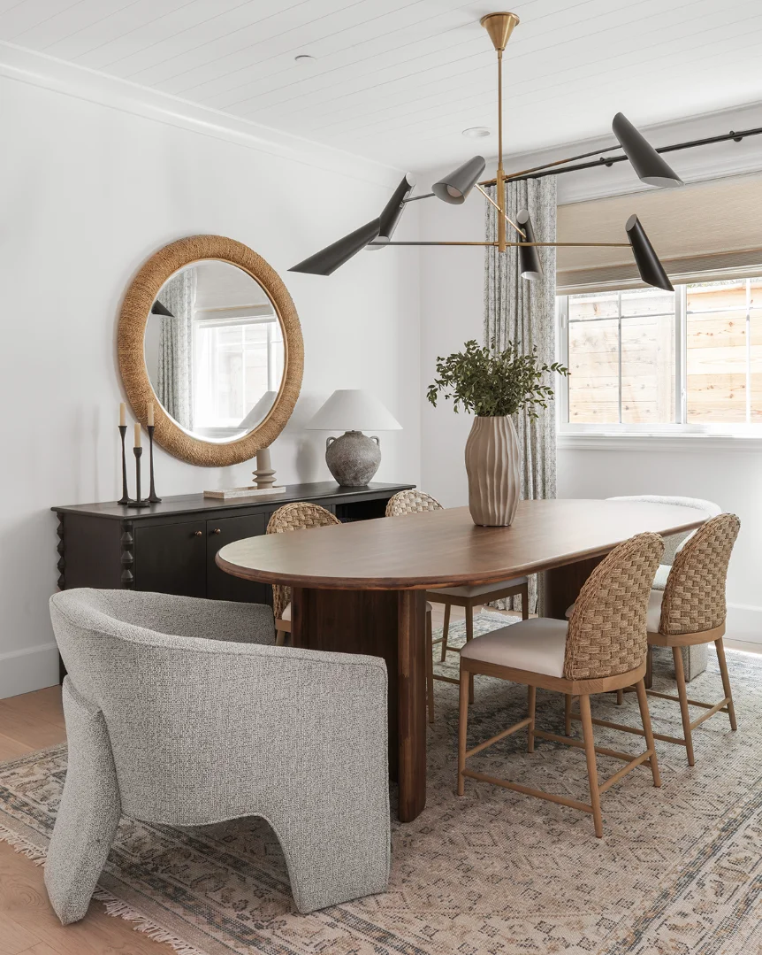 a dining room table with a mirror