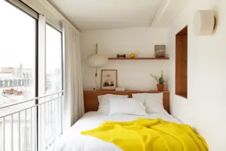 A tiny bedroom with one side dominated by a window