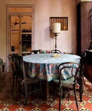 Pale pink rustic dining room with dark wooden furniture