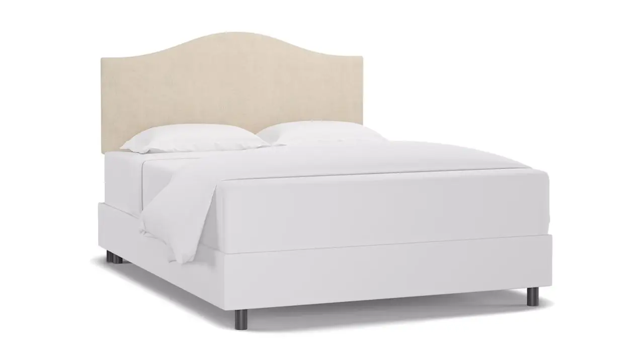 The Inside Cambelback Headboard set up on a bed on a white background.