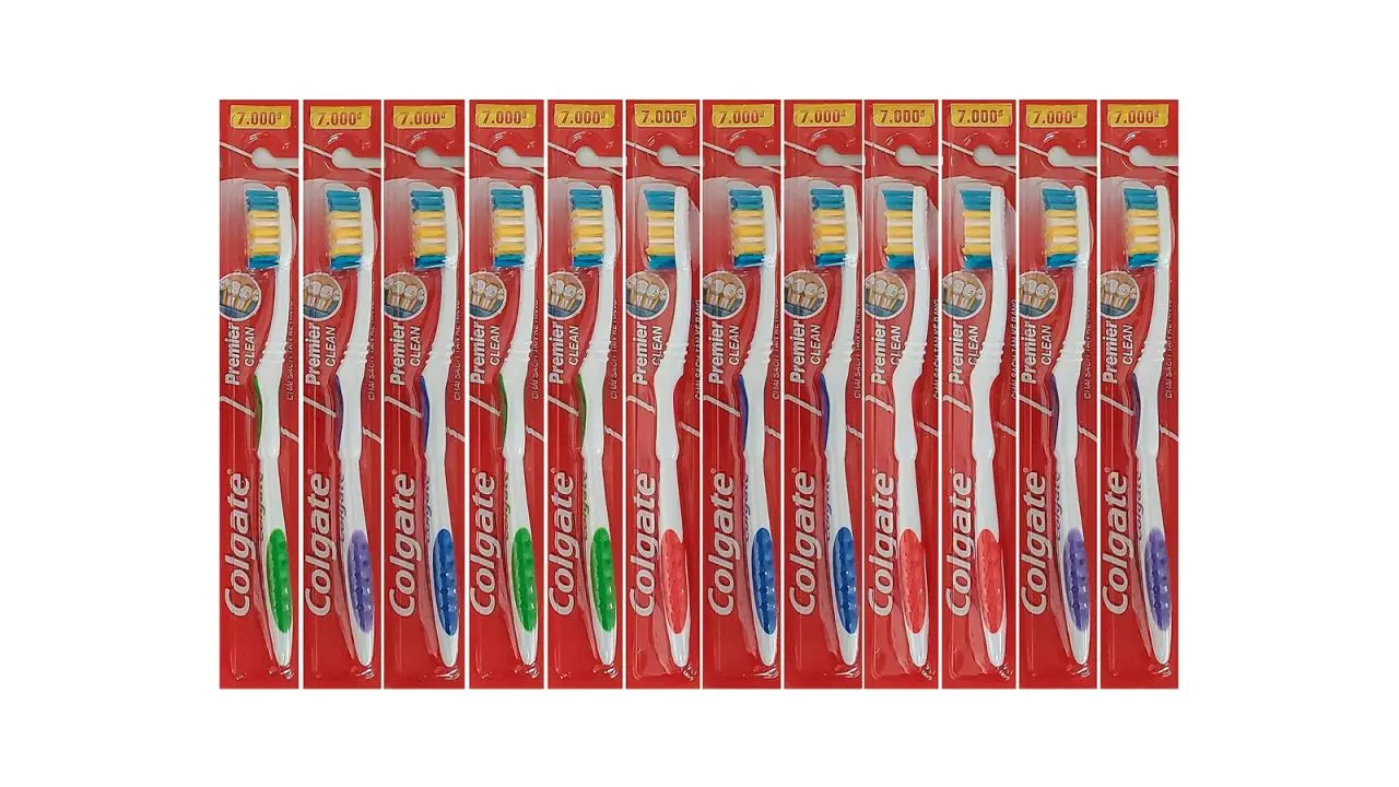 Twelve packaged Colgate toothbrushes.