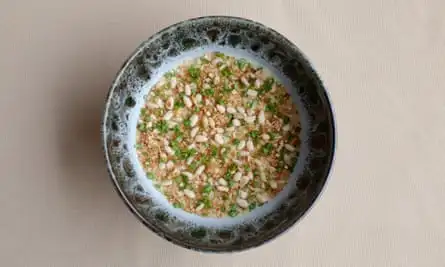 Caramelised onions soup under a crust of pine nuts, sourdough crumbs and herbs.