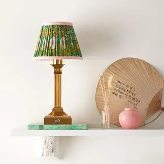 Freya rechargeable table lamp displayed on shelf with surrounding home decor