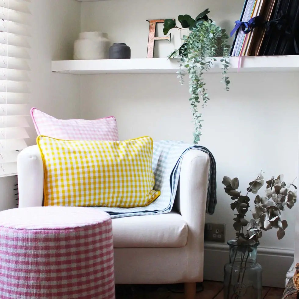 a white chair with a colorful pillow