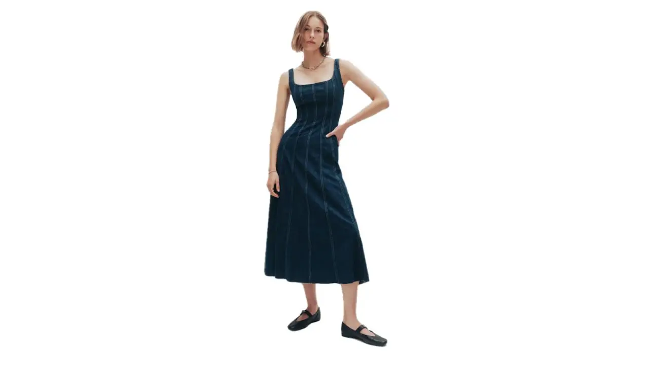 A woman in the Reformation Amory Denim Midi Dress.