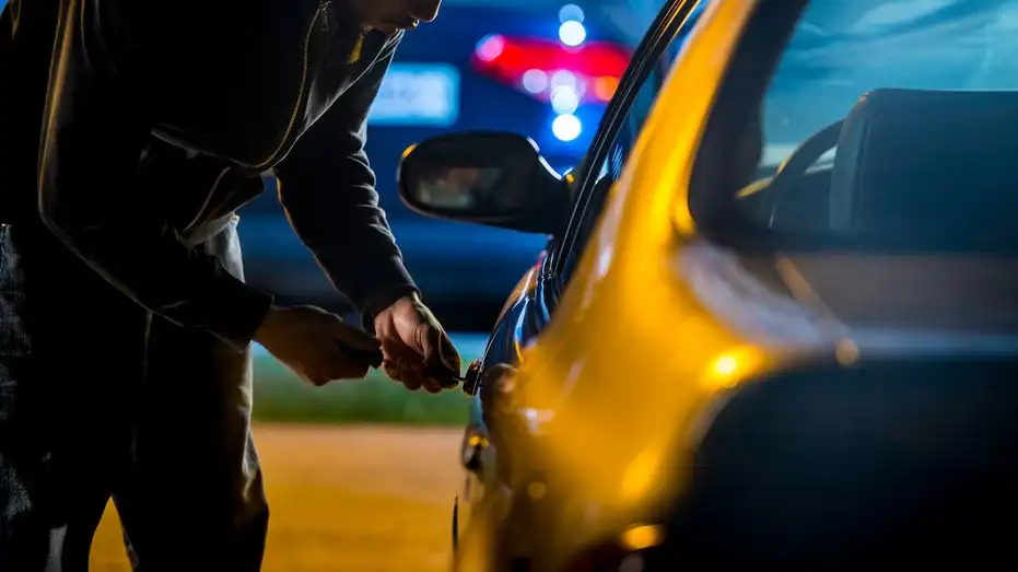 car thief trying to steal a car