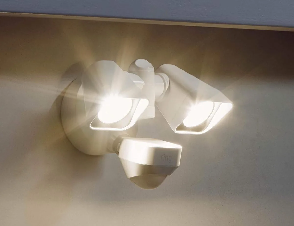 A close up of a motion sensor light shining at night. 