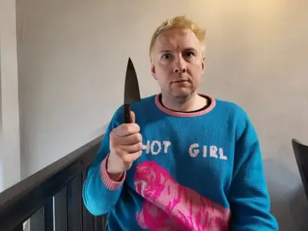 Joe Lycett holding a knife