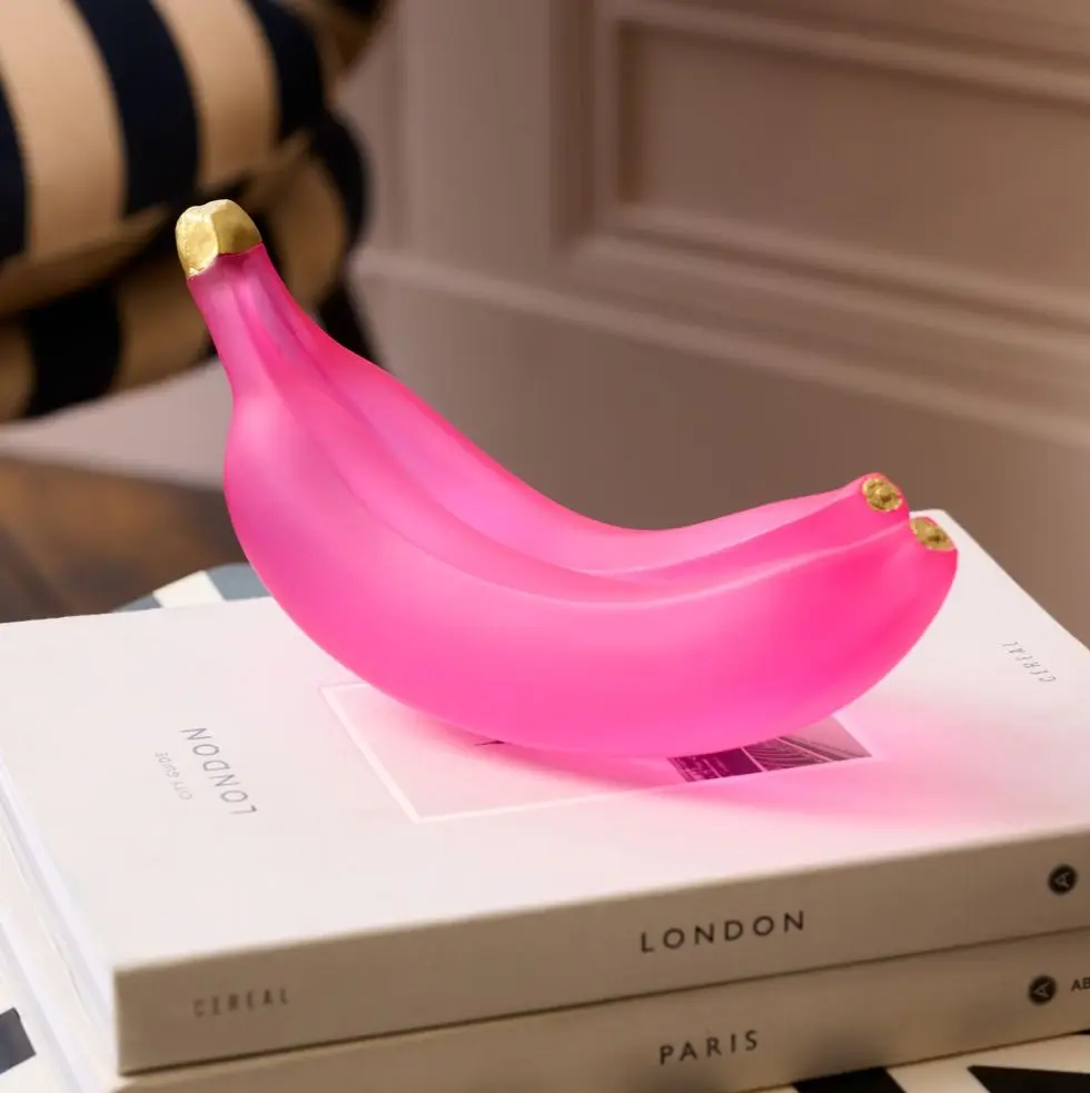 a pink banana and two mugs