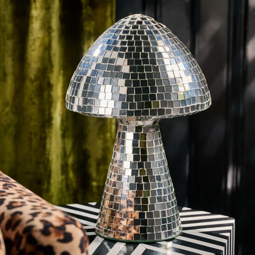 a large metal mirrored mushroom disco object