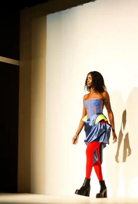 Chante Stonewall walks on stage while modeling a blue corset with a skirt designed by Ava Hercules during Stephens College's 80th annual fashion show, “The Collections,” Saturday, April 13 at Windsor Auditorium Stephens College in Columbia.