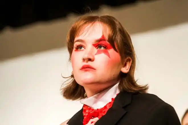 Wearing an '80s deconstructed suit dress designed by Arin Hawk, Alex Jockish looks toward the audience during Stephens College's 80th annual fashion show, “The Collections,” Saturday, April 13 at Windsor Auditorium in Columbia.