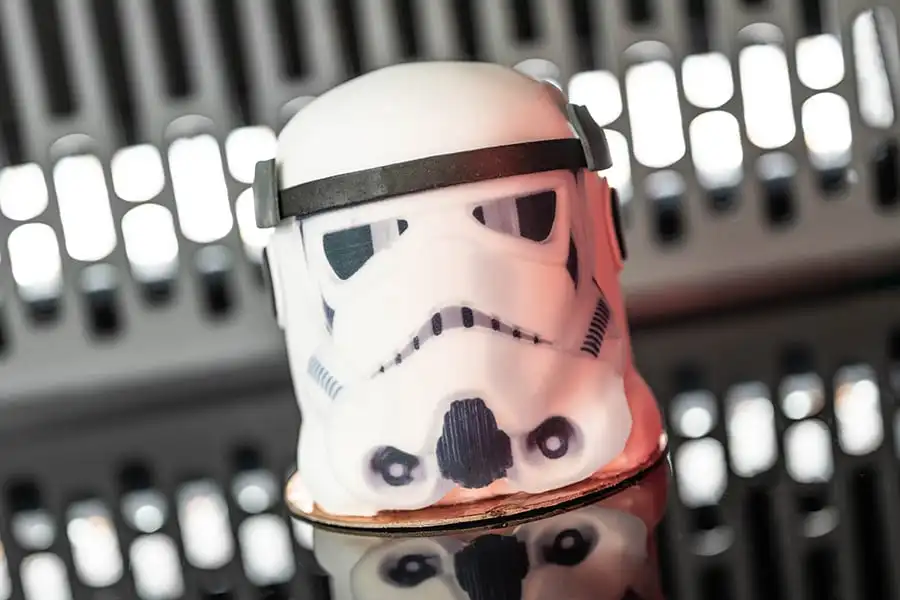 A Stormtrooper helmet dome cake sits in a Star Destroyer.