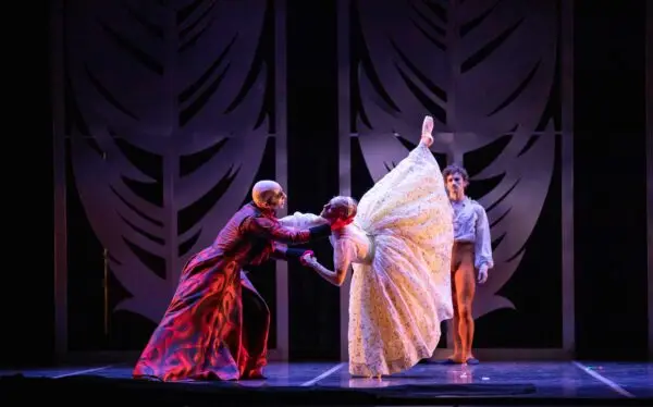 Photo of three ballet dancers on a stage