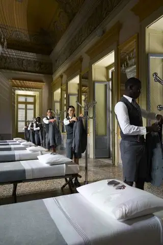 Thom Browne Frette Homeware Line at Milan Design Week: models dress beside perfectly made beds