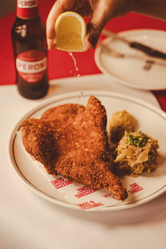 Pork cotoletta with braised cabbage and hot mustard.