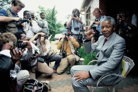 Nelson Mandela at home in Soweto, five days after his release from prison, surrounded by press photographers