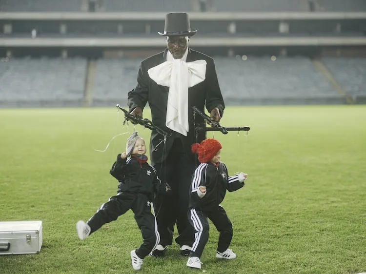 Puppeteer with puppets dressed in Orlando Pirates regalia