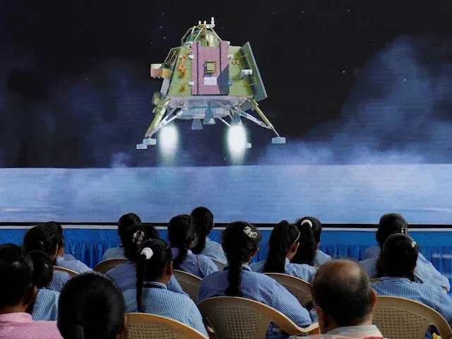 People watch a live stream of Chandrayaan-3 spacecraft's landing on the moon, inside an auditorium of Gujarat Science City in Ahmedabad, India, August 23, 2023. (Reuters)