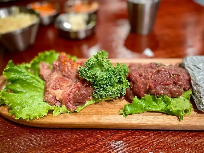 Bulgogi (marinated ribeye) and marinated lamb from Hanwoo Korean BBQ in Port Orange. Each meat is served raw, allowing guests to cook the meats to their liking using the table grill.