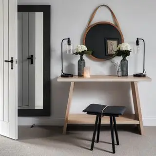 Wooden table and stool against a soft grey wall on grey carpet