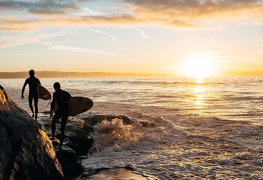 Two surfers heading out in the early morning near Santa Cruz.