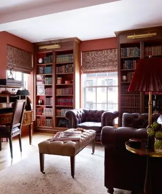 traditional red living room with large window and leather chairs