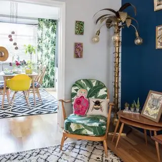 A living room with a tropical chair and floor lamp