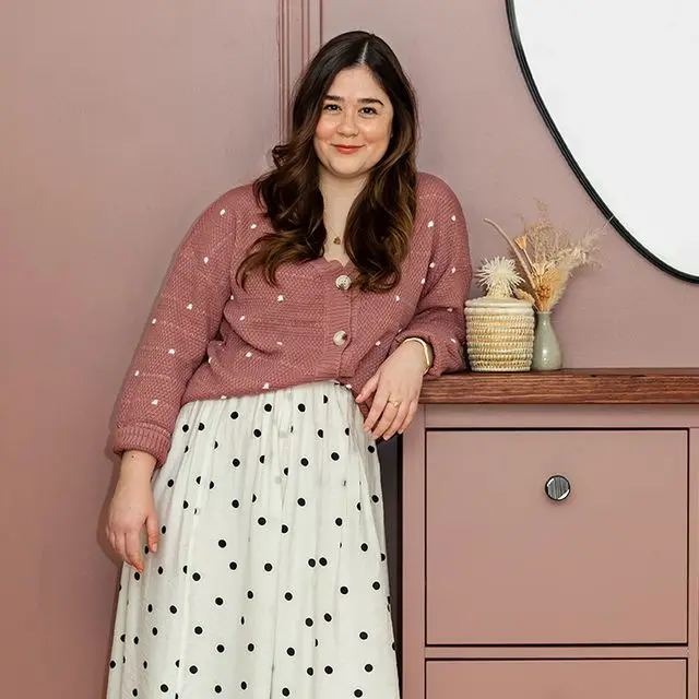 a woman posing in front of a mirror