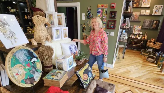 Laurie Long of Batavia looks at items at the newly-opened CāDō & Company store in downtown Batavia. (David Sharos / For The Beacon-News)