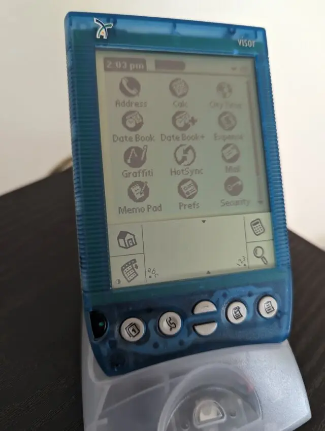 A Handspring Visor Deluxe in its new USB HotSync cradle.