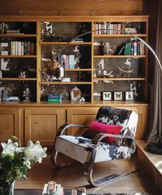 cabin with built in shelving and cow print chair