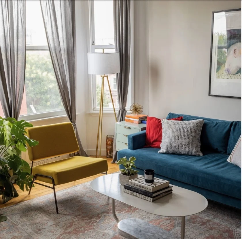 A mustard yellow chair and royal blue couch