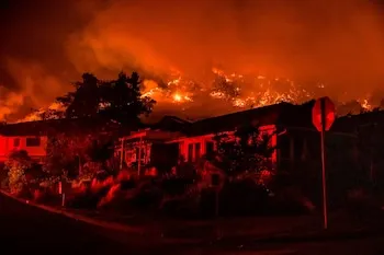 Wildfires seen on the hillside behind homes in Santa Rosa, California