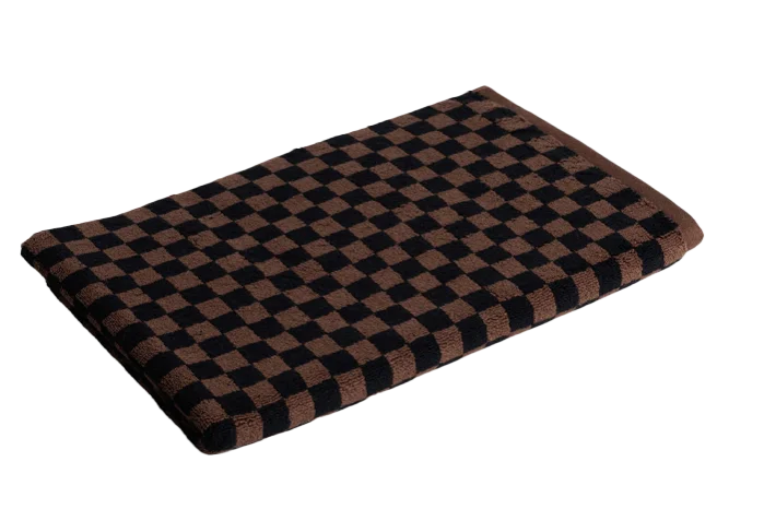 a square cotton bath mat with a checkered pattern