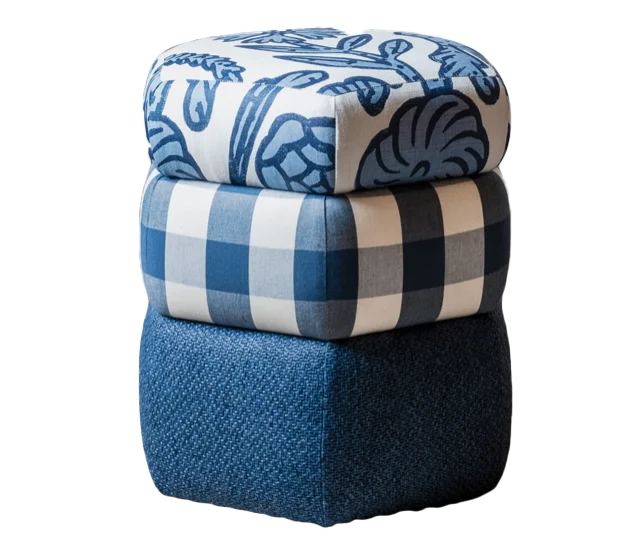 three puffy pillows stacked, each with a unique fabric pattern