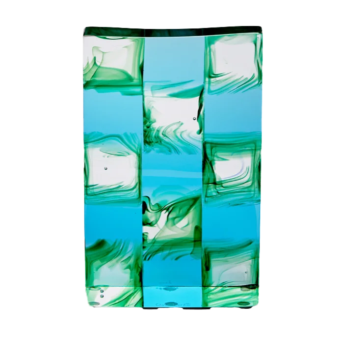 a square glass sculpture with a checkered pattern