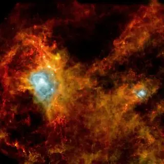 A reddish hazy view of space with two blue areas representing birthing stars.