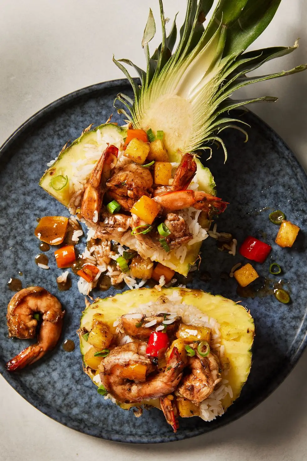 jerk marinated and grilled shrimp tossed with fresh pineapple and sweet bell pepper served over ice in a hollowed pineapple bowl