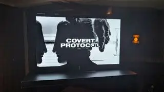 A photograph of a large TV displaying the Nvidia ACE 'Covert Protocol' demo.